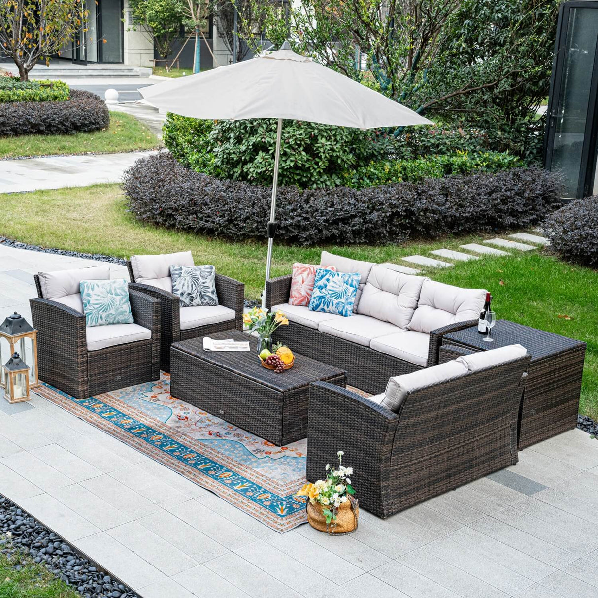 Outdoor patio furniture set with cushions and an umbrella on a patio.