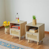 Two wooden nightstands with books, a bottle, and a plant on a wooden floor.